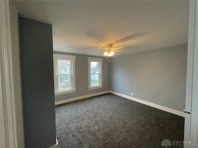 carpeted spare room featuring ceiling fan