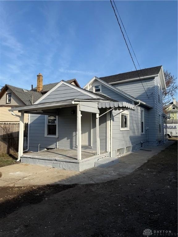 back of house featuring a porch