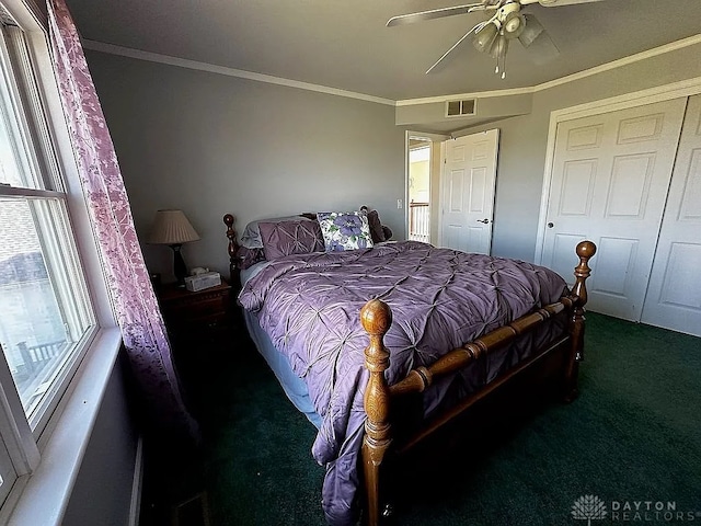 carpeted bedroom featuring ceiling fan and ornamental molding