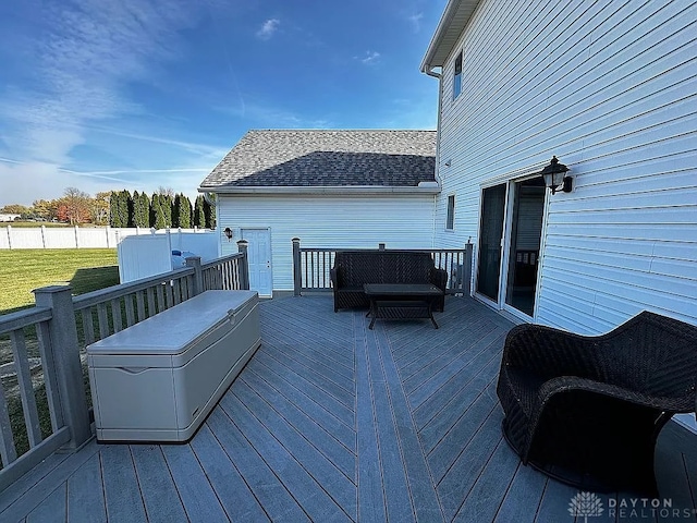 wooden deck with a lawn