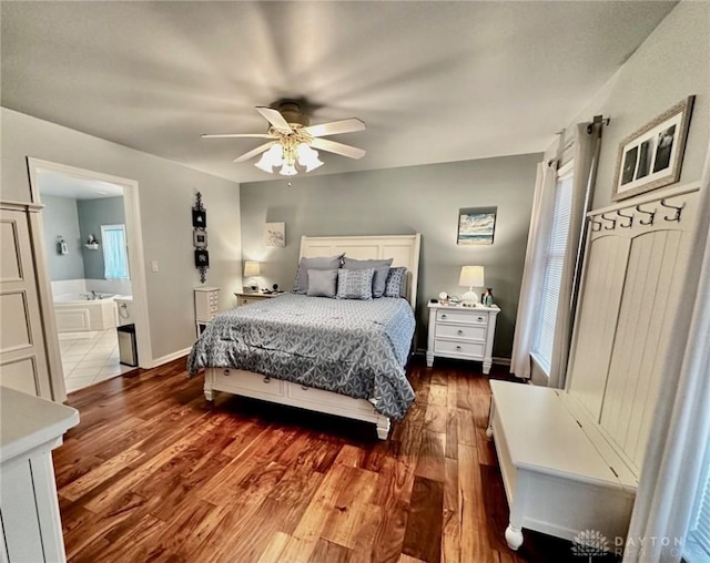 bedroom featuring hardwood / wood-style flooring, ceiling fan, and connected bathroom