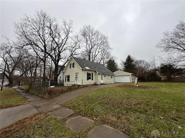 view of home's exterior featuring a garage, an outdoor structure, and a lawn