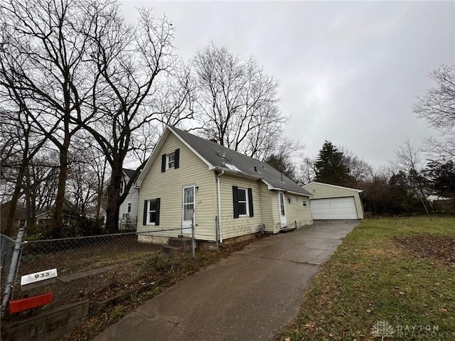 view of front facade with a garage and an outbuilding