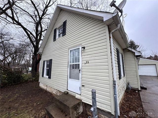 view of home's exterior featuring an outbuilding and a garage