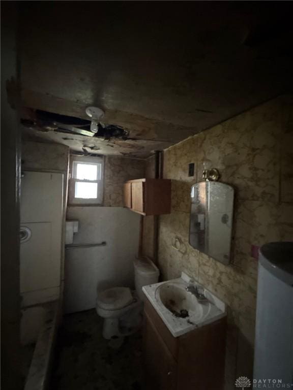 bathroom featuring vanity, toilet, and electric panel