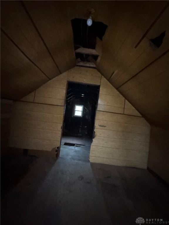 additional living space featuring wood ceiling, wooden walls, and vaulted ceiling