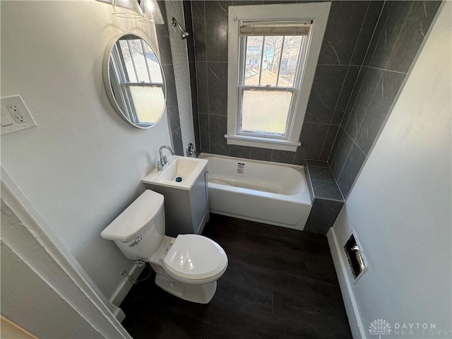 bathroom with a tub to relax in, wood-type flooring, toilet, and vanity