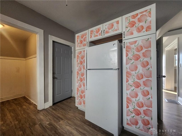 kitchen with dark hardwood / wood-style flooring and white fridge