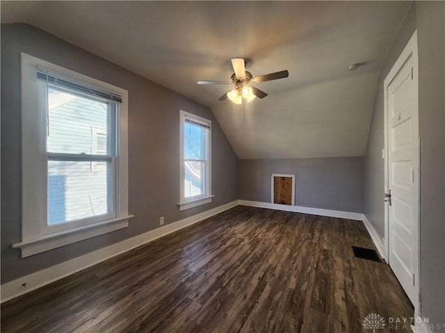 bonus room featuring ceiling fan, lofted ceiling, dark wood-type flooring, and a wealth of natural light