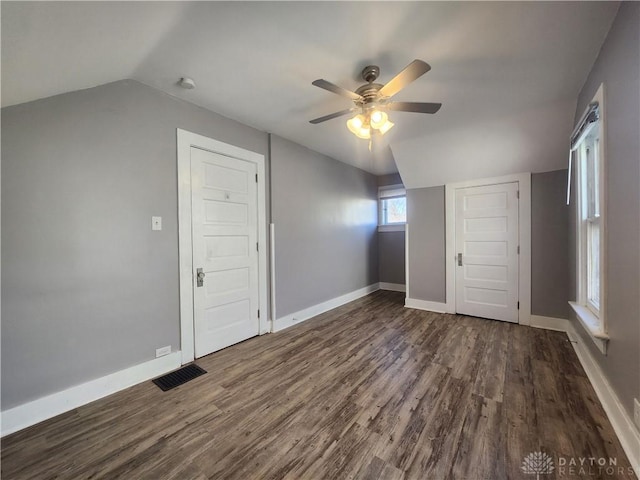 additional living space featuring dark wood-type flooring, ceiling fan, and lofted ceiling