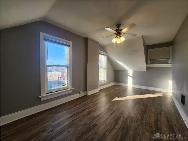 additional living space featuring ceiling fan, dark wood-type flooring, and lofted ceiling