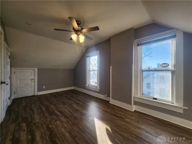 bonus room with ceiling fan, dark hardwood / wood-style floors, and lofted ceiling