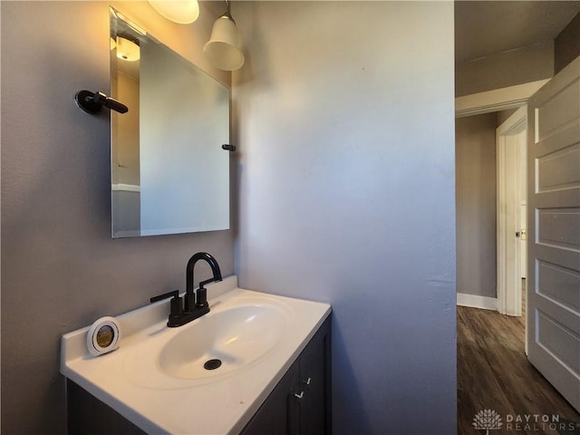 bathroom with hardwood / wood-style floors and vanity