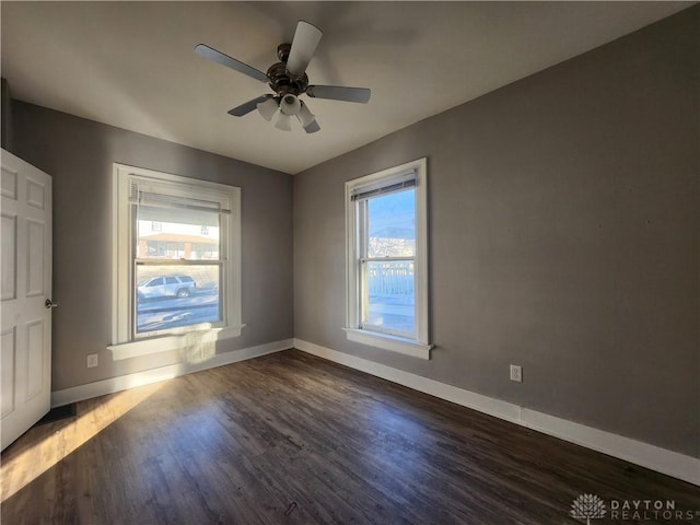 empty room with ceiling fan and dark hardwood / wood-style floors