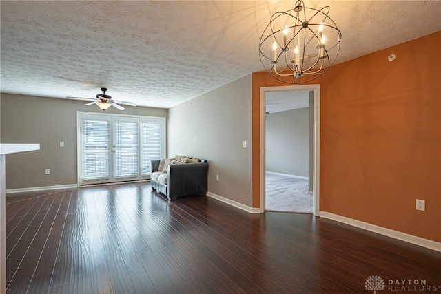 interior space featuring a textured ceiling, ceiling fan with notable chandelier, and dark hardwood / wood-style floors