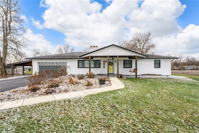 ranch-style home with a garage, driveway, a carport, and a front yard