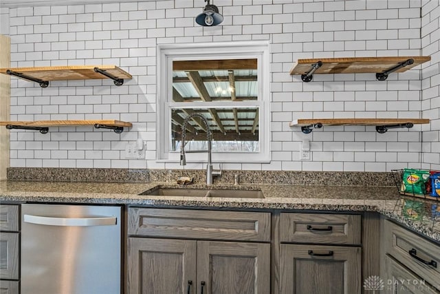 kitchen with dishwasher, open shelves, dark stone counters, and decorative backsplash