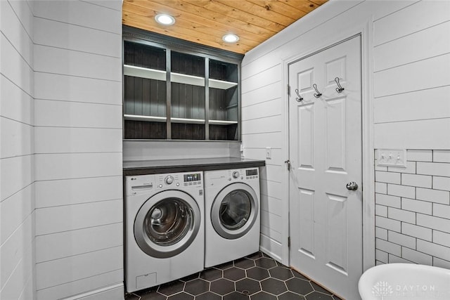 laundry area with wooden ceiling, recessed lighting, laundry area, dark tile patterned flooring, and washing machine and clothes dryer