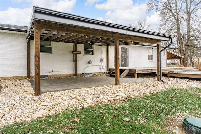 rear view of house featuring a carport and brick siding