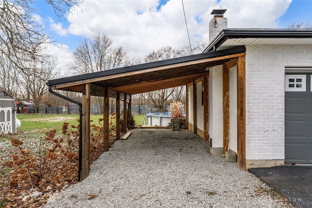 view of parking with a garage, driveway, and a carport