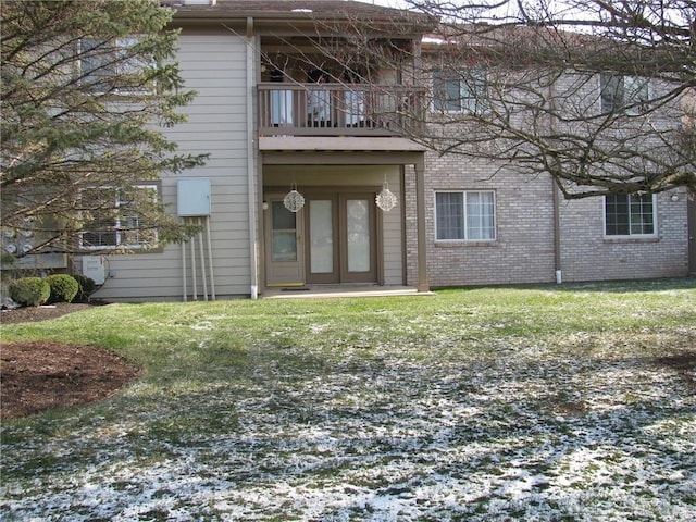 exterior space with a lawn and a balcony