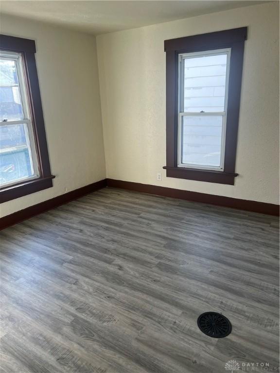 unfurnished room featuring dark wood-type flooring