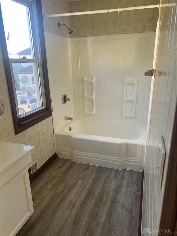 bathroom featuring vanity, hardwood / wood-style flooring, and tiled shower / bath combo