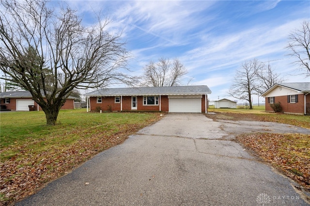 single story home with a garage and a front yard