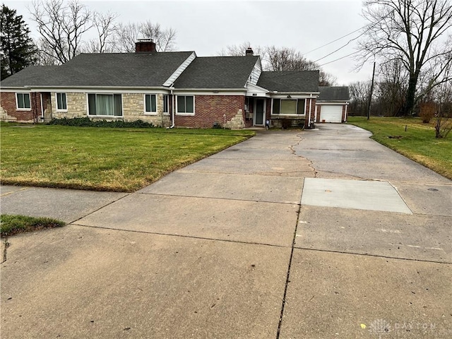 single story home with a garage and a front lawn