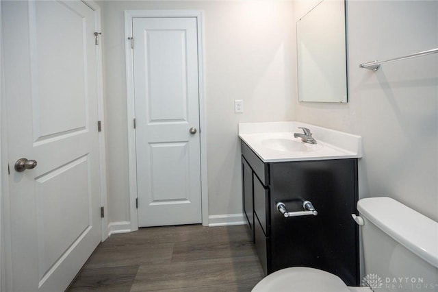 bathroom featuring hardwood / wood-style floors, vanity, and toilet