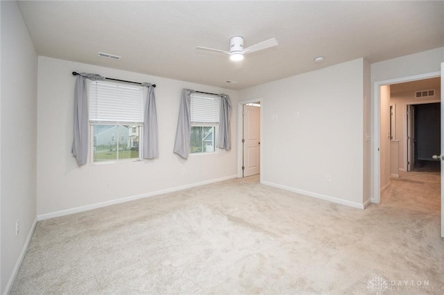 empty room with ceiling fan and light colored carpet