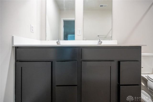 bathroom with vanity and toilet