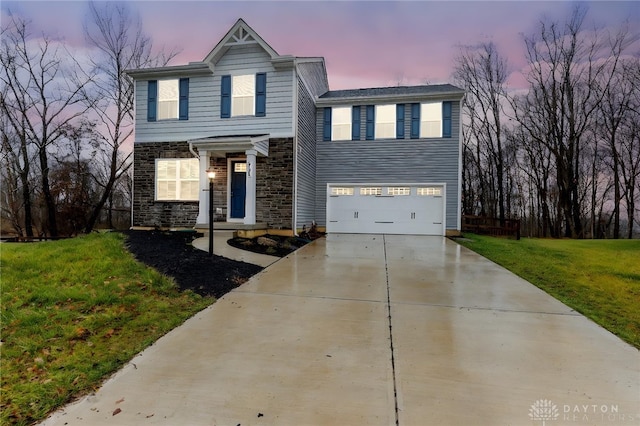 view of front of property featuring a garage and a yard