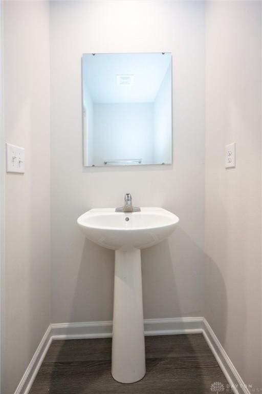 bathroom with hardwood / wood-style floors