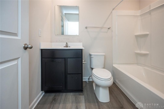 full bathroom with bathtub / shower combination, vanity, hardwood / wood-style flooring, and toilet