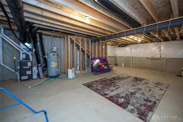 basement featuring heating unit and water heater