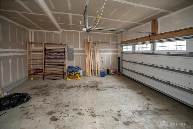 garage featuring electric panel and a garage door opener