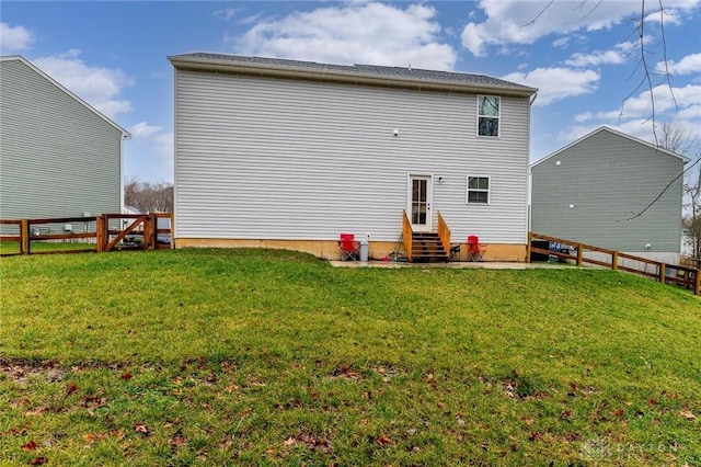 rear view of house featuring a yard