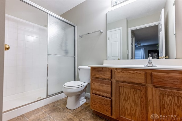 bathroom with tile patterned flooring, vanity, an enclosed shower, and toilet