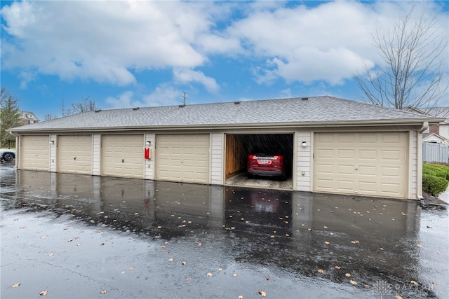 view of front of property with a garage and an outdoor structure