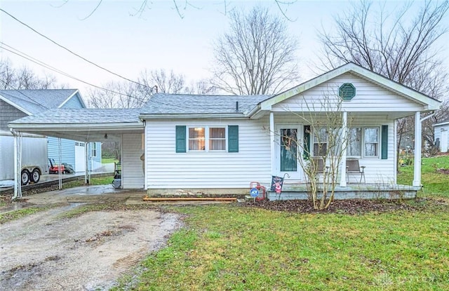 view of front of house with a front lawn, a porch, and a carport