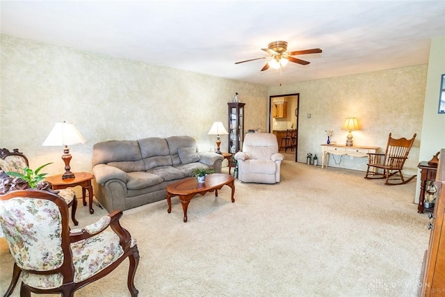 carpeted living room with ceiling fan