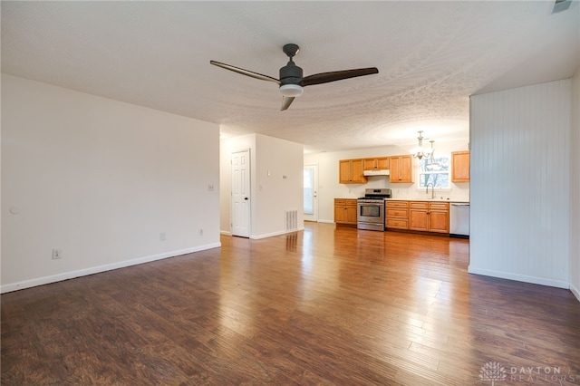 unfurnished living room featuring ceiling fan with notable chandelier, a textured ceiling, dark hardwood / wood-style floors, and sink