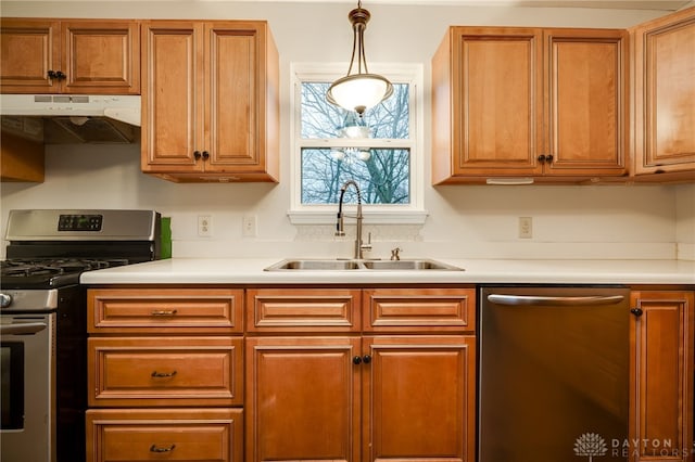 kitchen featuring sink, stainless steel appliances, and hanging light fixtures