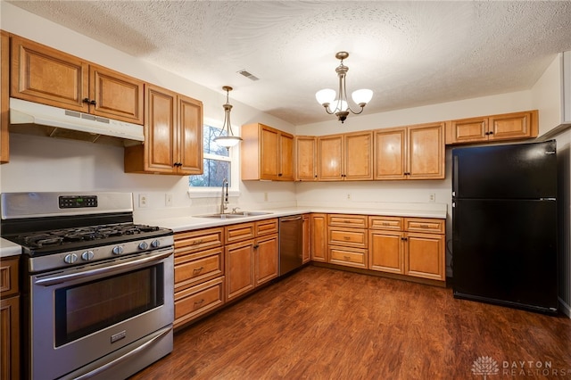 kitchen with dark hardwood / wood-style flooring, sink, hanging light fixtures, and appliances with stainless steel finishes