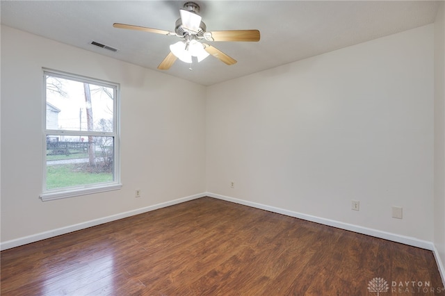 spare room with ceiling fan and dark wood-type flooring