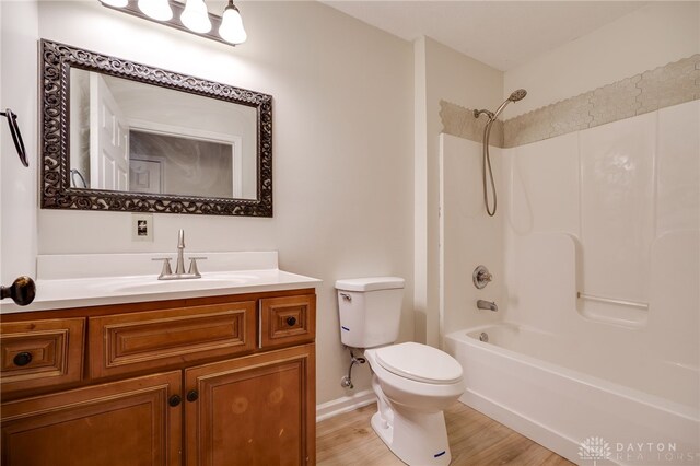 full bathroom with hardwood / wood-style floors, vanity, toilet, and bathing tub / shower combination