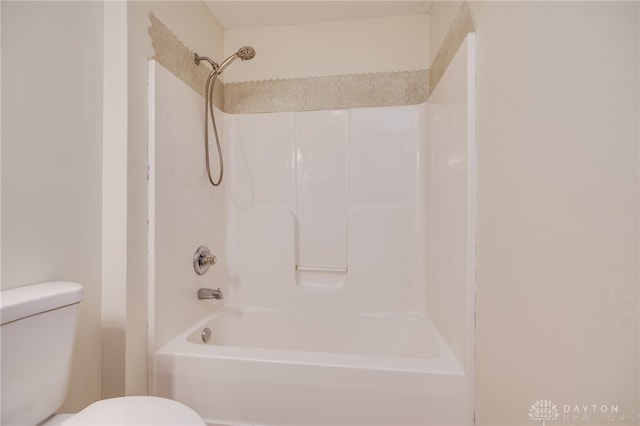 bathroom with shower / bathing tub combination and toilet