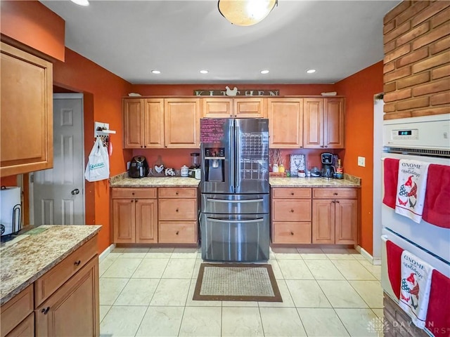 kitchen with light stone countertops, white double oven, light tile patterned flooring, and fridge with ice dispenser