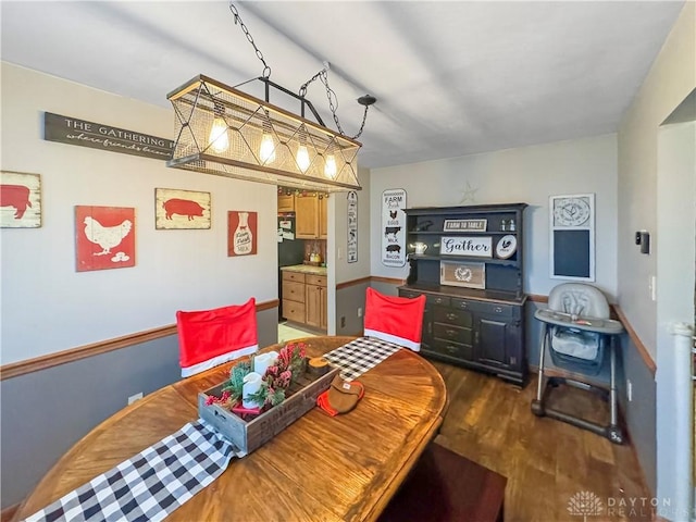 dining space featuring dark wood-type flooring